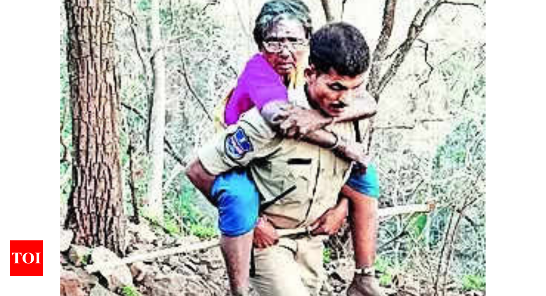 Police Officer Carries Elderly Devotee on His Back Through Rocky Terrain